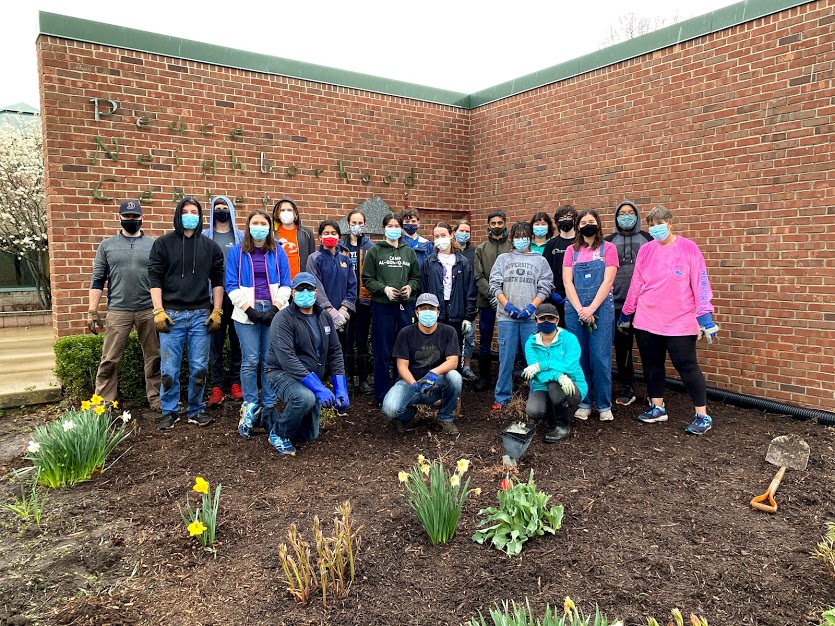 Rain or shine (or both), alumni determined to finish spring landscaping at Peace